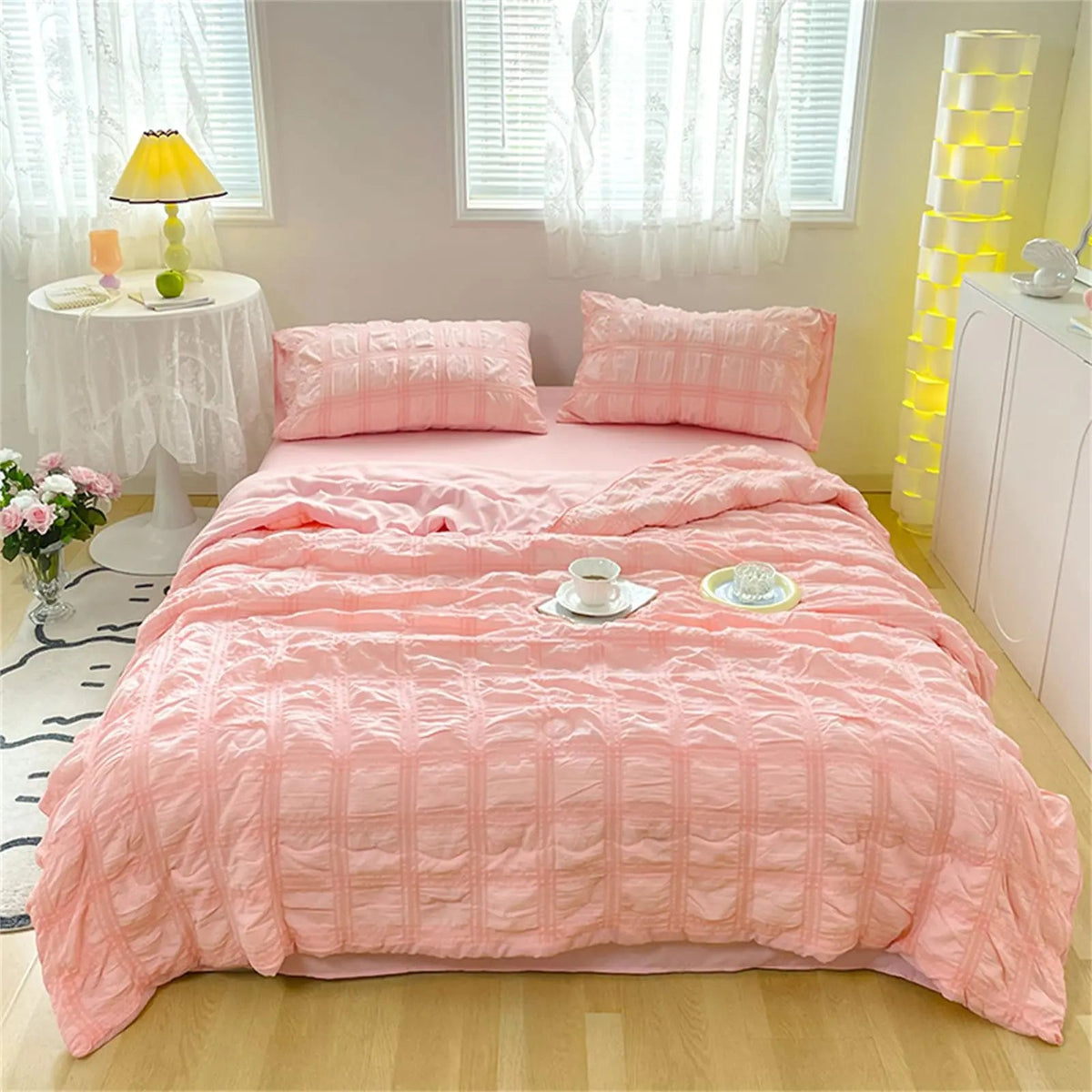 Soft pastel seersucker quilt on a made bed