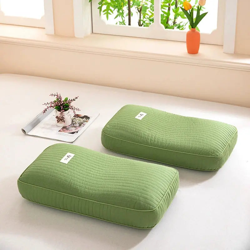 Light Green buckwheat pillows on a bed by a window