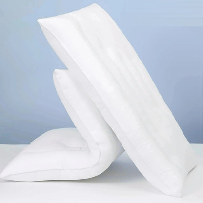 Two white low loft cotton pillows leaning against each other